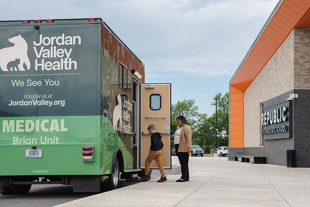 CHW and Child Entering Mobile Unit