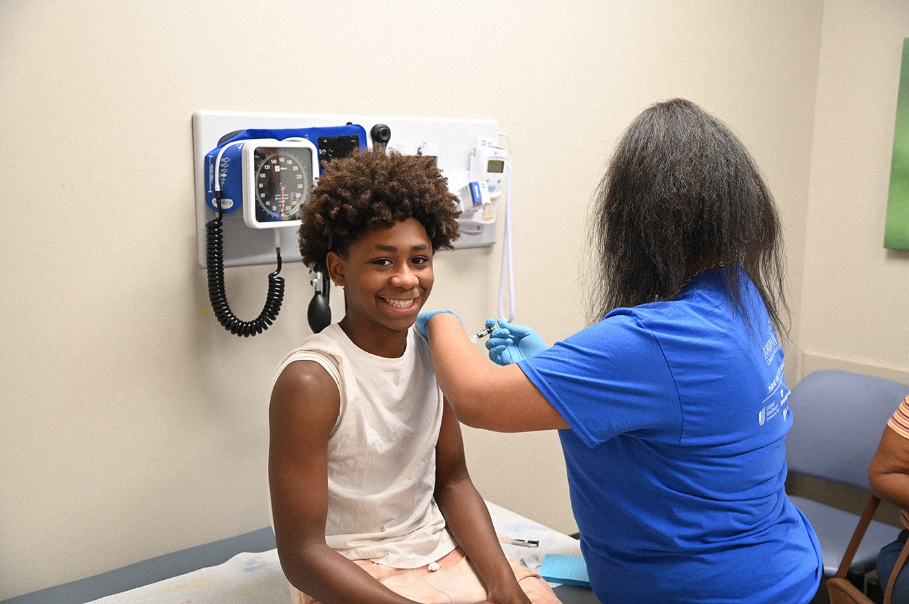Child Receives Shot from Provider