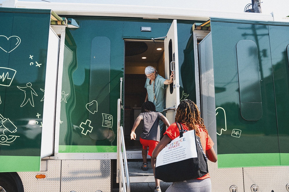 Provider Welcoming Patient on to Mobile Unit